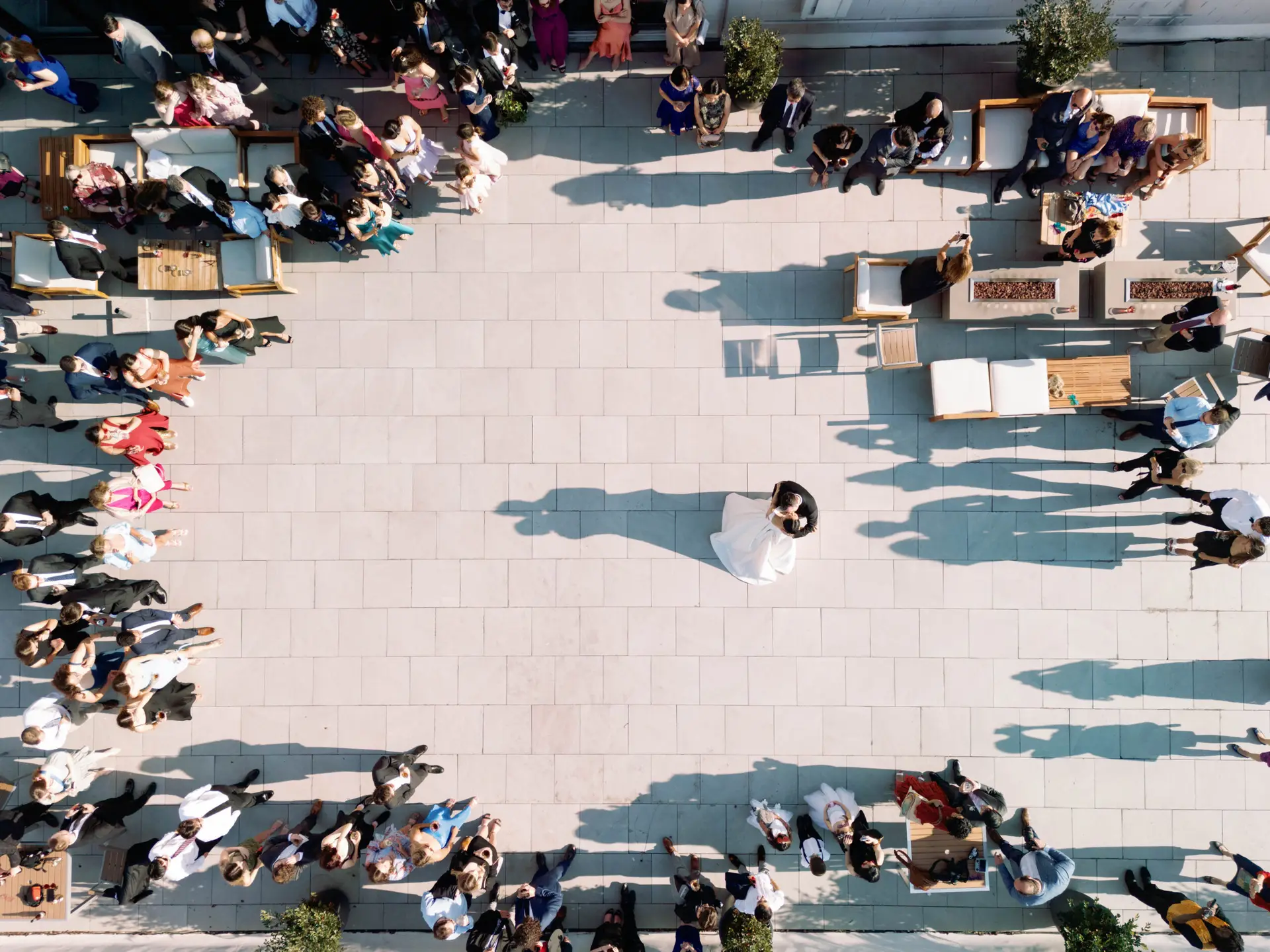 Bride and groom share first dance on rooftop surrounded by guests at The Faulkner in Jackson, Mississippi.